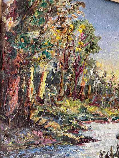 Impasto oil painting of a sunlit woodland stream framed by trees under a pale blue sky, in a gold gilt frame