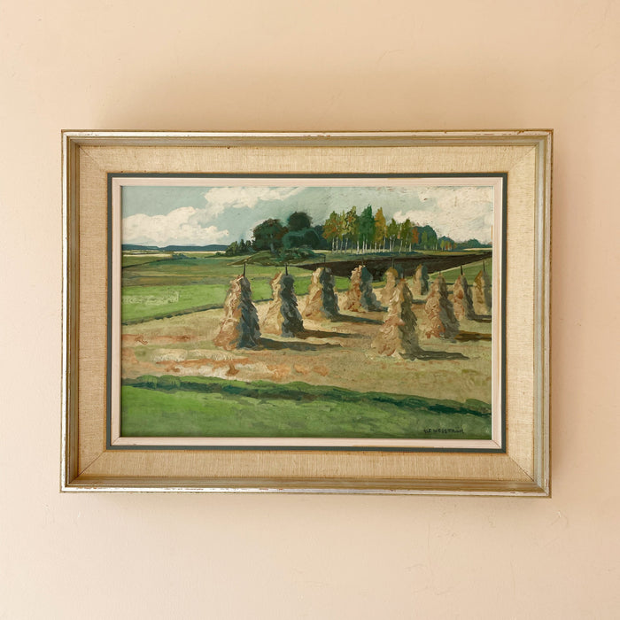 Original mid century oil painting of haystacks drying on poles in a sunlit field, with birch trees and a summer sky. Signed, framed and ready to hang.