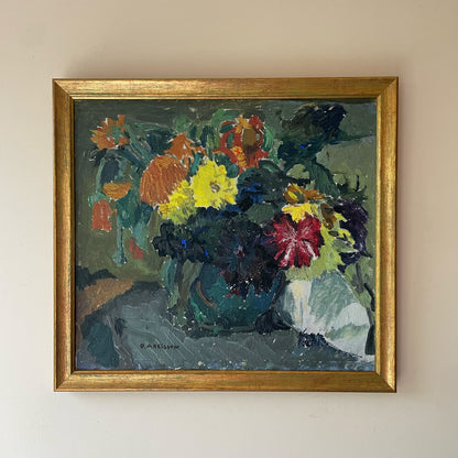 Framed painting of a floral arrangement on a beige wall