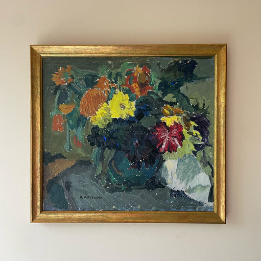 Framed painting of a floral arrangement on a beige wall