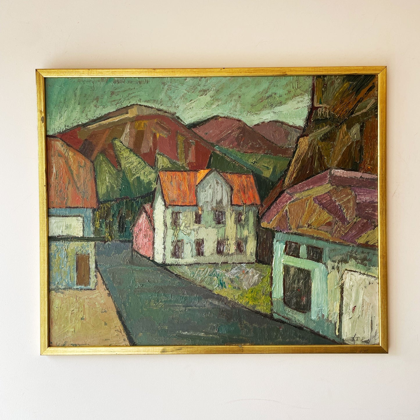 Vintage mid-century expressionist oil painting, European village street with terracotta roofs, rust hills and green sky, gilt framed.