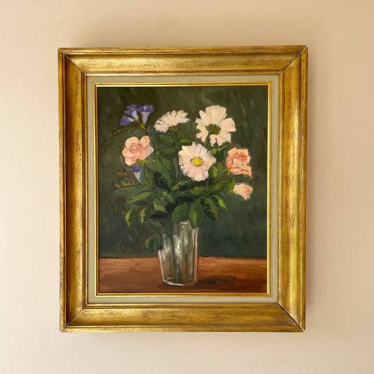 Original mid century floral still life of pink roses, white daisies and blue flowers in a glass vase, in a deep gilt frame. Signed and ready to hang.