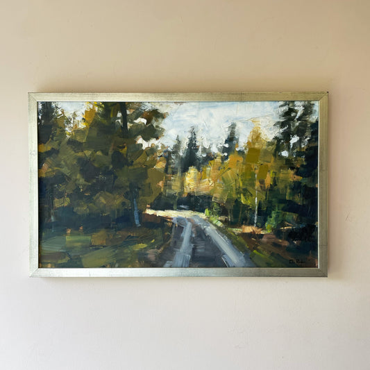 A vintage mid-century landscape oil painting of a road winding through dense woodland, in deep greens, ochre and grey.